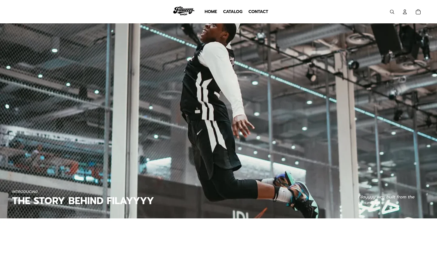 The desktop page features a large hero image of a person jumping in a basketball gym, overlaid with the headline 'THE STORY BEHIND FILAYYYY'. Below the hero section, a clean white layout presents centered text about the brand's mission interspersed with several vertical lifestyle images. The navigation bar at the top is minimalist with a logo, links for Home, Catalog, and Contact, and icons for search, user, and cart.