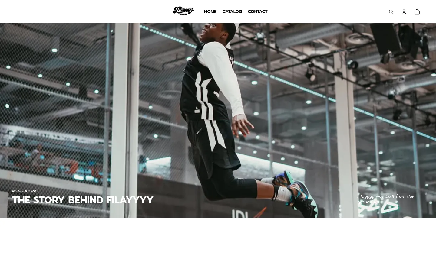 The desktop page features a large hero image of a person jumping in a basketball gym, overlaid with the headline 'THE STORY BEHIND FILAYYYY'. Below the hero section, a clean white layout presents centered text about the brand's mission interspersed with several vertical lifestyle images. The navigation bar at the top is minimalist with a logo, links for Home, Catalog, and Contact, and icons for search, user, and cart.
