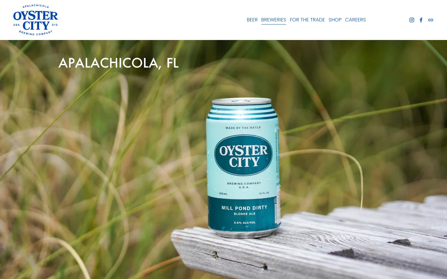 The desktop page features a navigation menu at the top with links for Beer, Breweries, For the Trade, Shop, and Careers. A large hero image shows a light blue can of Mill Pond Dirty Blonde Ale sitting on a weathered wooden surface against a background of tall grass, with the headline 'APALACHICOLA, FL' overlaid in white.