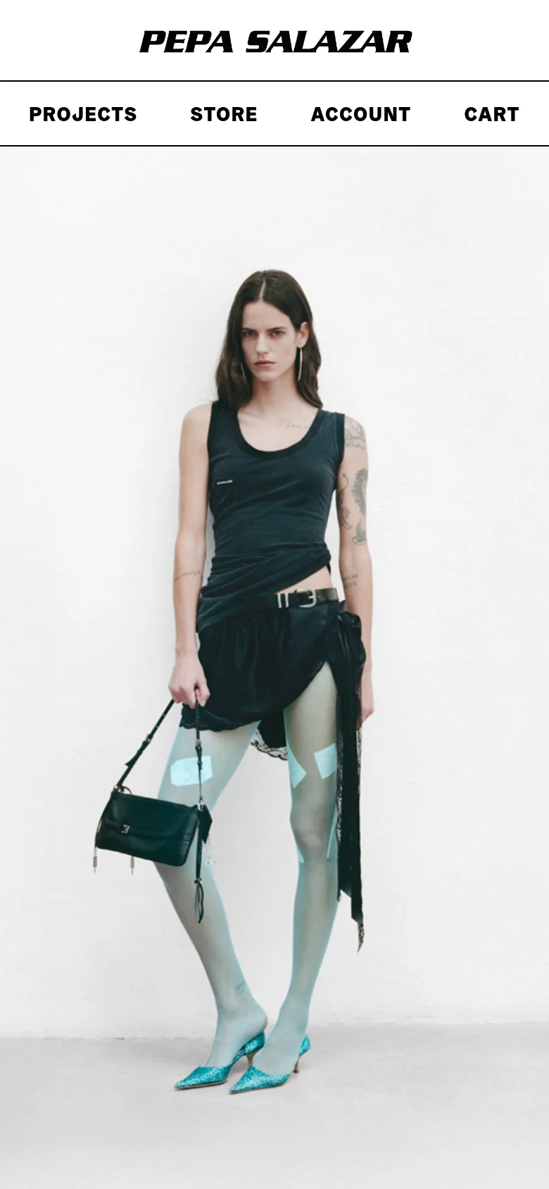 The mobile version displays a centered PEPA SALAZAR logo above a full-width navigation menu containing Projects, Store, Account, and Cart. Below the menu, the large hero image of the model is scaled to fit the vertical screen, maintaining the minimalist aesthetic.