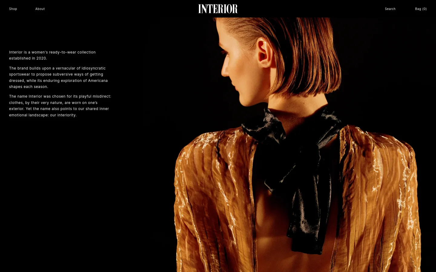 The desktop About page features a dark, minimalist layout with white text on the left side describing the brand's history and philosophy. A large, high-contrast hero image on the right shows a woman in profile wearing a shimmering, golden-brown sheer garment with a black bow. The navigation bar at the top includes links for Shop, About, Search, and Bag.