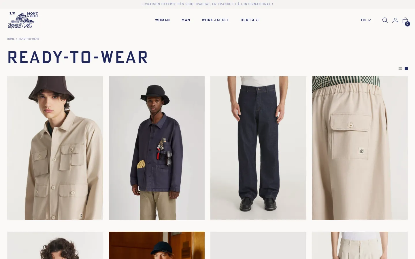 The desktop version of the Ready-to-Wear category page features a clean, minimalist layout with a white background and dark blue typography. A navigation menu at the top includes links for Woman, Man, Work Jacket, and Heritage, alongside search and account icons. Below the large 'READY-TO-WEAR' headline, a grid of high-quality product images displays various men's garments, such as work jackets and trousers.