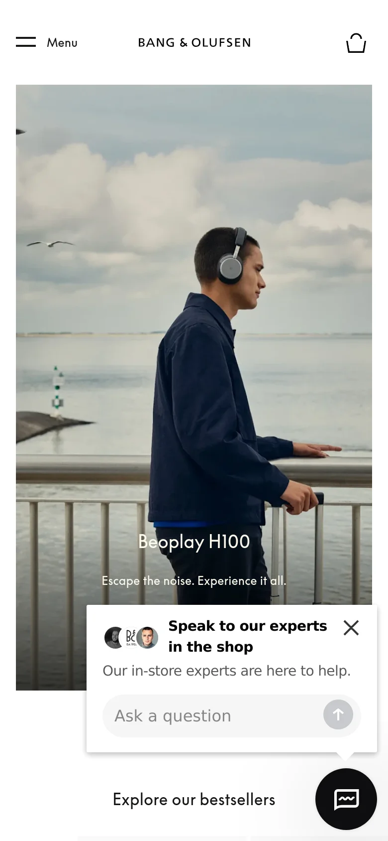 The mobile version presents a vertically stacked layout starting with the hero image of the man by the sea, with the headline and 'Learn more' button centered. A floating chat widget and a 'Speak to our experts' pop-up appear at the bottom, while the navigation is condensed into a hamburger menu and a shopping bag icon.