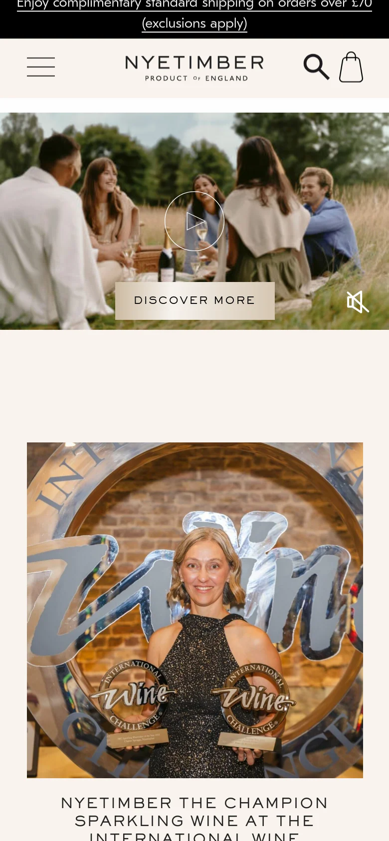 The mobile version displays a large video hero section showing people enjoying wine outdoors, with a 'DISCOVER MORE' call-to-action button. Below the video, the layout shifts to a vertical stack of large, high-quality images highlighting award-winning news and brand achievements.
