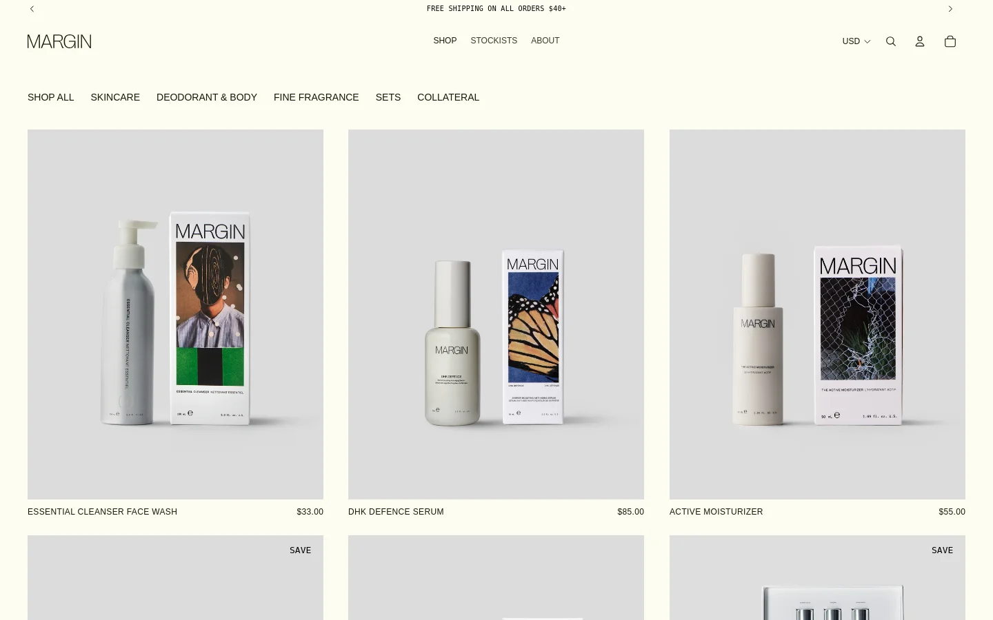 The desktop shop page features a minimalist design with a light gray background and a clean navigation menu at the top. A grid of skincare products is displayed, including the Essential Cleanser, DHK Defence Serum, and Active Moisturizer, each shown with its product packaging and price. The layout is spacious, using high-quality product photography against neutral tones.
