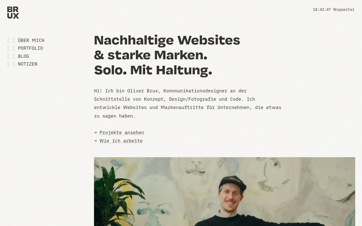 Desktop homepage for Oliver Brux, a communication designer, featuring a minimalist white and light grey layout. A large bold headline reads 'Nachhaltige Websites & starke Marken. Solo. Mit Haltung.' followed by an introductory paragraph and two text links with arrows. The left sidebar contains the 'BRUX' logo and a navigation menu, while a large portrait photo of Oliver is positioned below the text.