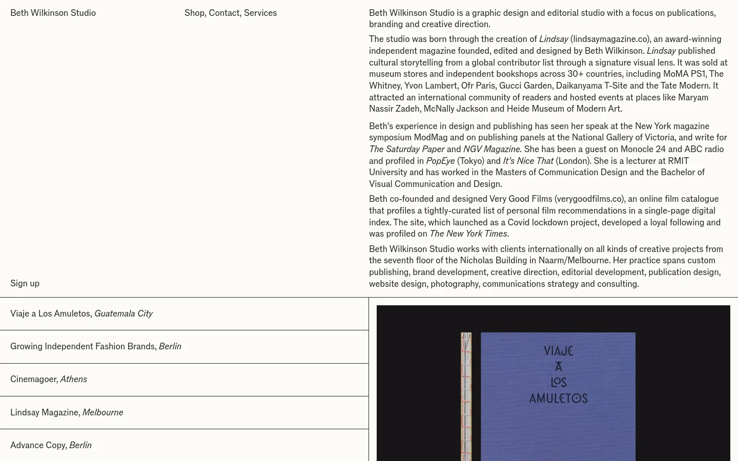 The desktop homepage for Beth Wilkinson Studio features a minimalist layout with a white background and black serif typography. The top navigation includes the studio name on the left and links for Shop, Contact, and Services on the right, while a large text block describes the studio's history and services. A vertical list of projects with locations is on the left, and a large, partially visible image of a book cover is on the right.