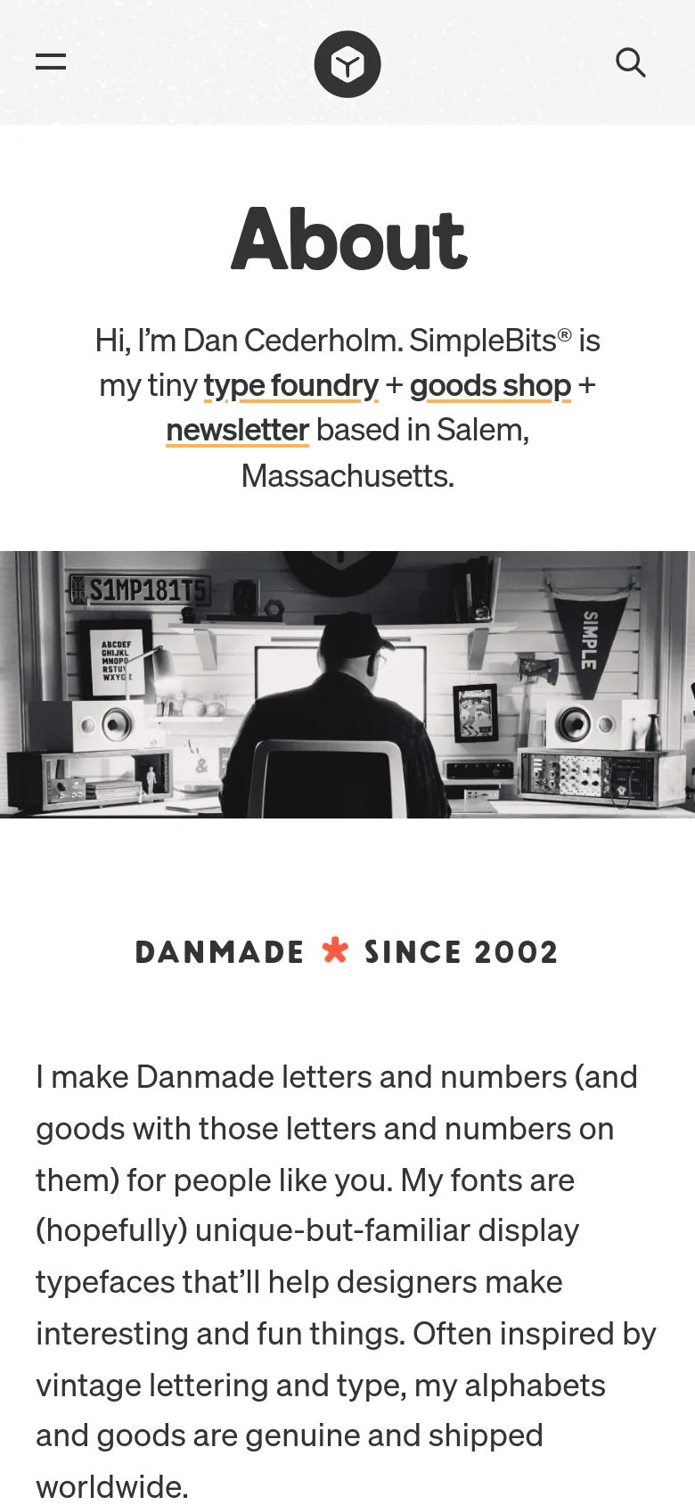 The mobile version displays a simplified header with a hamburger menu icon, a central logo, and a search icon. The 'About' heading and introductory text are centered, followed by the same black and white studio hero image, which spans the width of the screen.