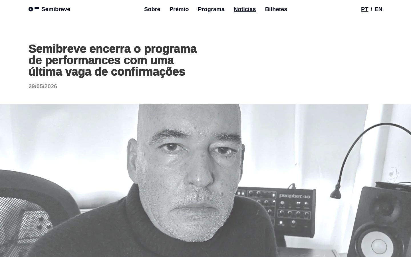 The news page features a large headline in black sans-serif font on a white background, followed by a date and a large black-and-white hero photograph of a man in a studio setting. The desktop layout includes a top navigation bar with links for Sobre, Prémio, Programa, Notícias, and Bilhetes, alongside a language switcher.