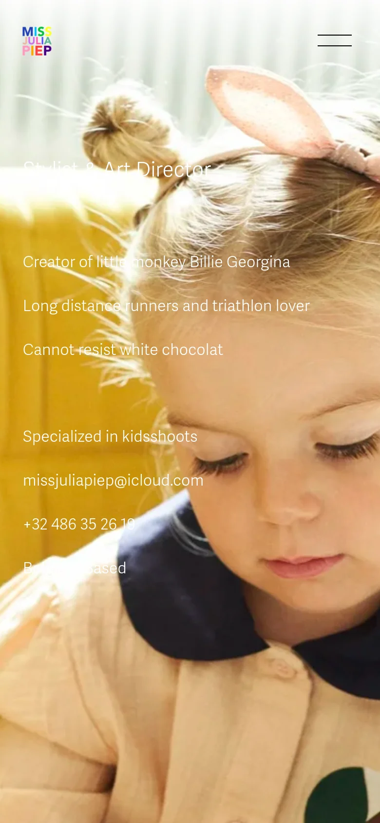 The mobile version simplifies the layout, removing the top navigation menu and replacing it with a hamburger icon. The large colorful logo remains at the top left, but the text content is centered and overlaid directly onto the close-up portrait of the child. The background remains a warm, bright image of the girl, maintaining the same soft aesthetic as the desktop version.