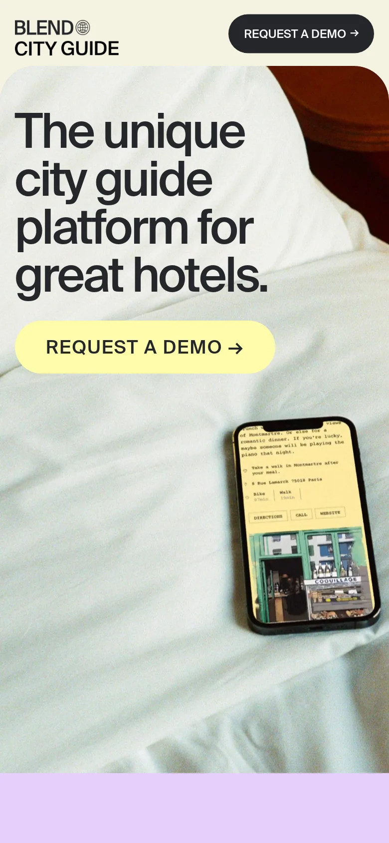 Mobile version of the homepage with a vertically stacked layout. The headline is centered above a large yellow 'REQUEST A DEMO' button, and the smartphone displaying the digital guide is positioned below the button against a white bed background.