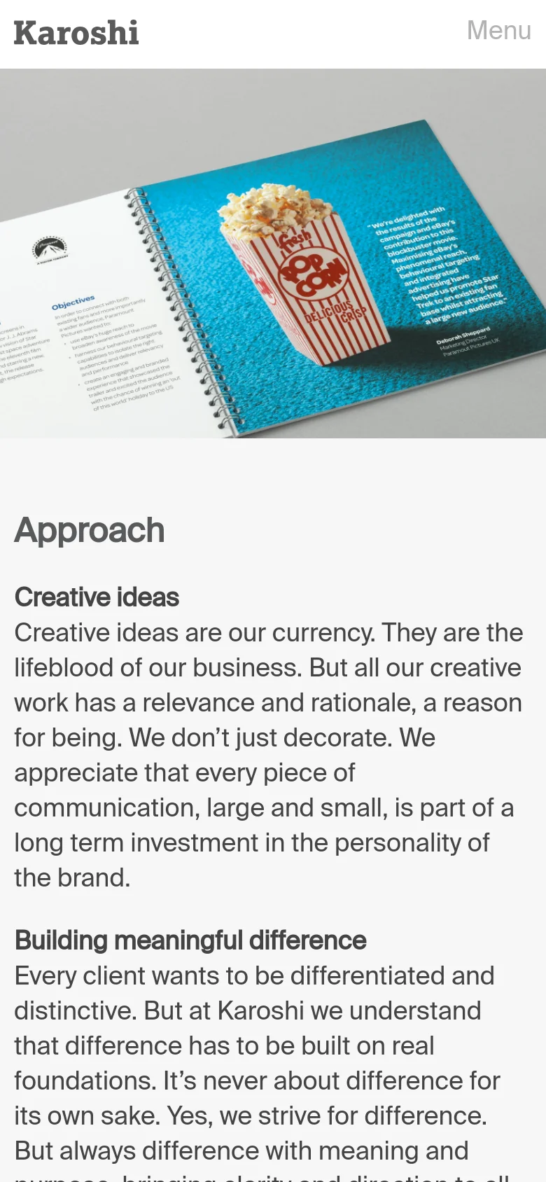 The mobile version simplifies the layout, replacing the top navigation bar with a single 'Menu' label next to the Karoshi logo. The hero image of the magazine remains prominent, but the text content below is stacked vertically for easier scrolling on a narrow screen.