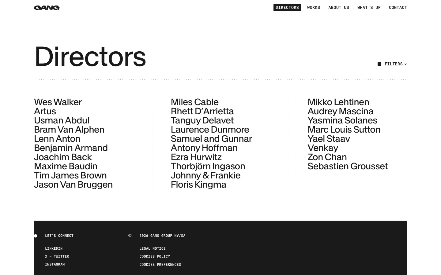 The desktop version of the Directors page features a minimalist white background with a large black 'Directors' headline. A list of director names is organized into three clean columns, and a 'FILTERS' dropdown menu is located on the right side. The footer is a solid black block containing contact links and legal information.