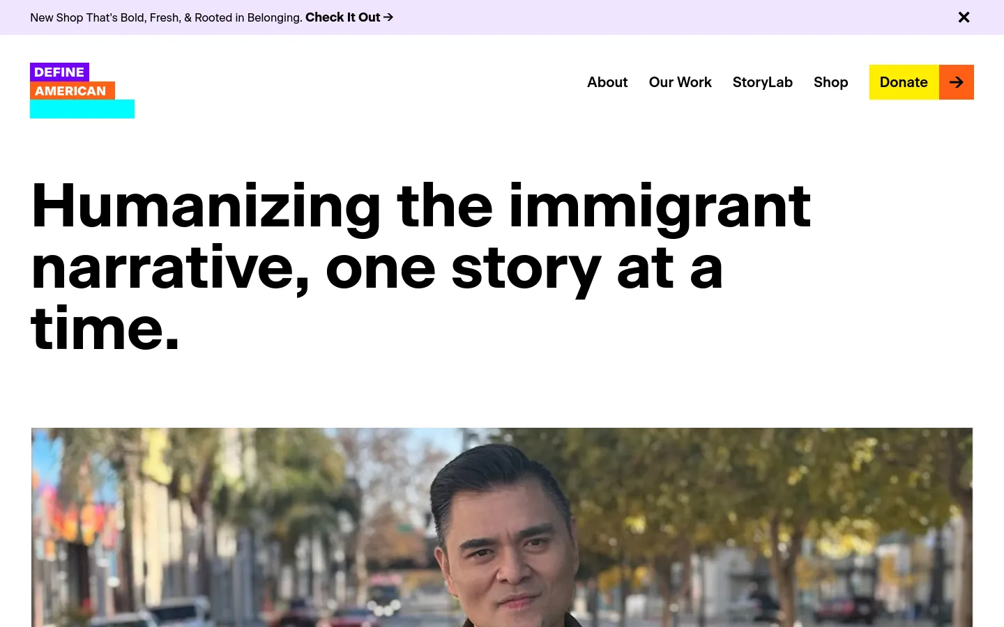 The desktop homepage features a large, bold headline reading 'Humanizing the immigrant narrative, one story at a time.' below a navigation menu with links for About, Our Work, StoryLab, and Shop, alongside a yellow 'Donate' button. A large hero image of Jose Antonio Vargas is positioned below the headline, set against a light lavender background.