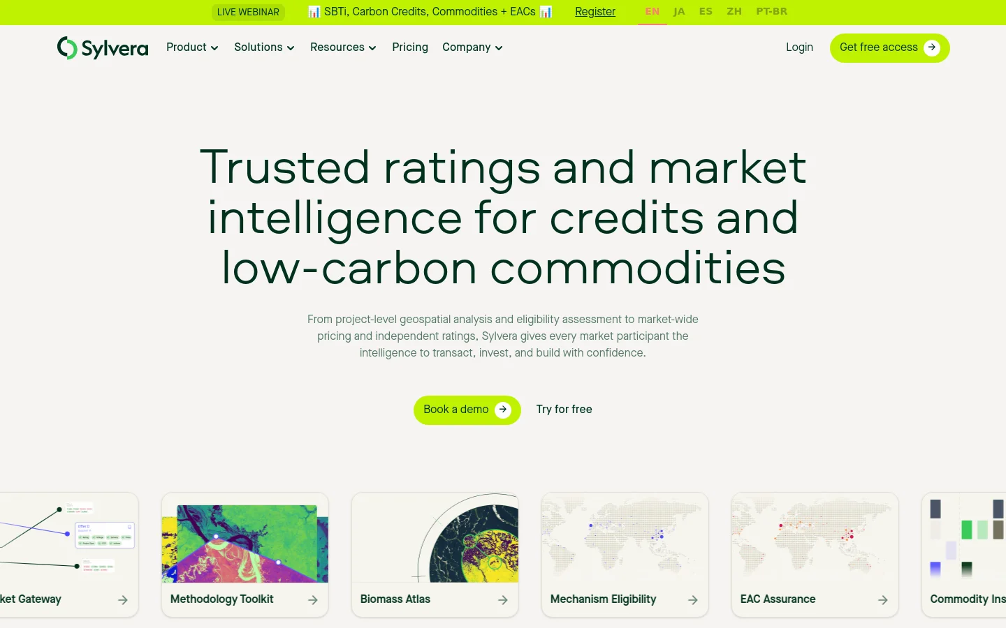 The Sylvera homepage features a clean, white background with a large headline about carbon credit ratings and market intelligence. A lime green 'Book a demo' button is centered below the subtext, and a top navigation bar includes links for Product, Solutions, and Pricing. Below the hero section, a row of feature cards with colorful geospatial imagery and arrows displays different services like Methodology Toolkit and Biomass Atlas.