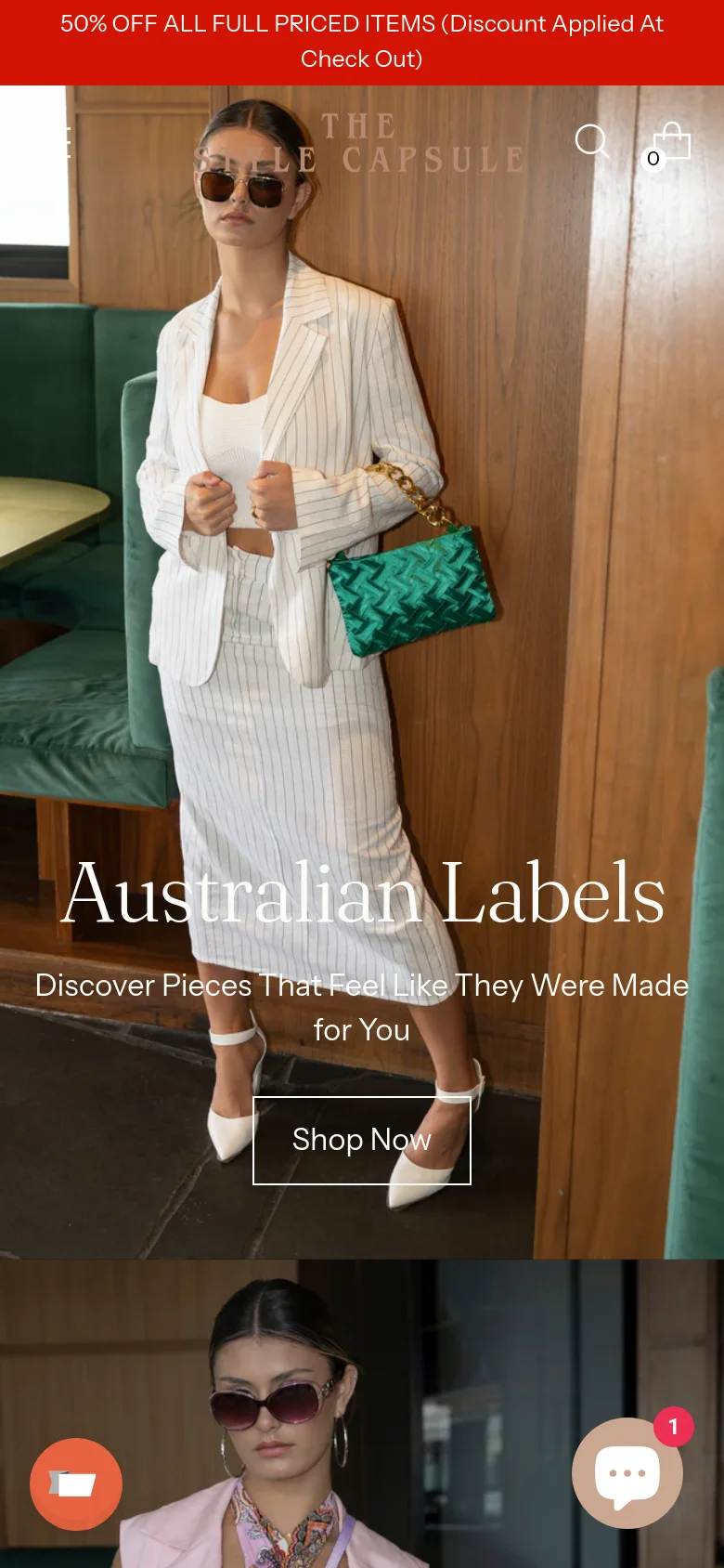 The mobile version presents a vertically stacked layout starting with a red announcement bar and a centered logo. The hero image is cropped to focus on a single woman in a white pinstripe suit, with the 'Australian Labels' headline and 'Shop Now' button overlaid on the image. Navigation is condensed into a search icon and a shopping bag icon at the top.