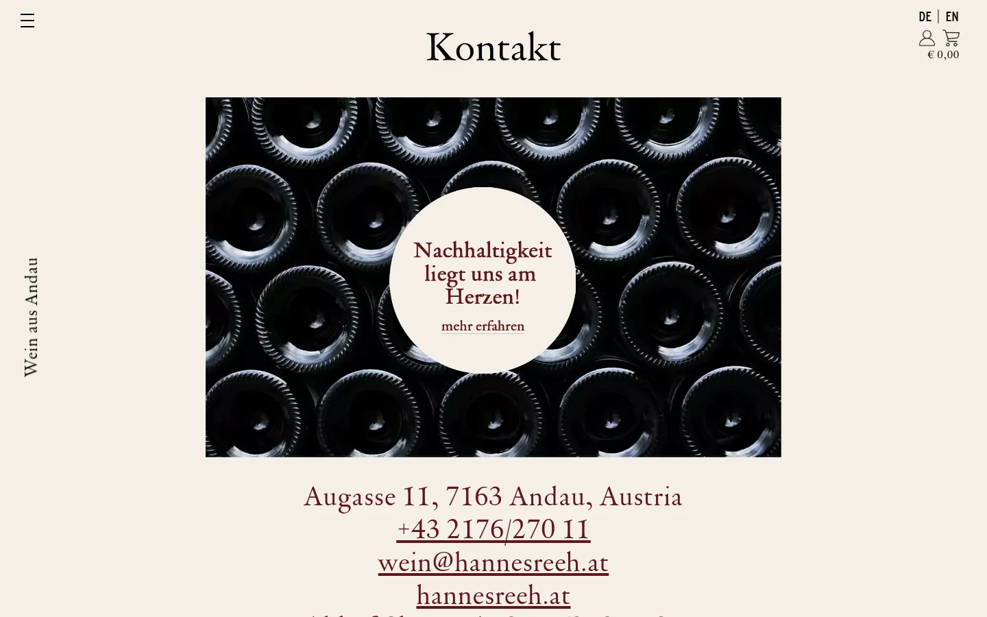 The desktop contact page features a large hero image of dark wine bottle bottoms with a central white circle containing the text 'Nachhaltigkeit liegt uns am Herzen! mehr erfahren'. Below the image, the winery's address, phone number, email, and website are displayed in large, elegant serif typography against a light beige background. A vertical text element 'Wein aus Andau' runs along the left margin.