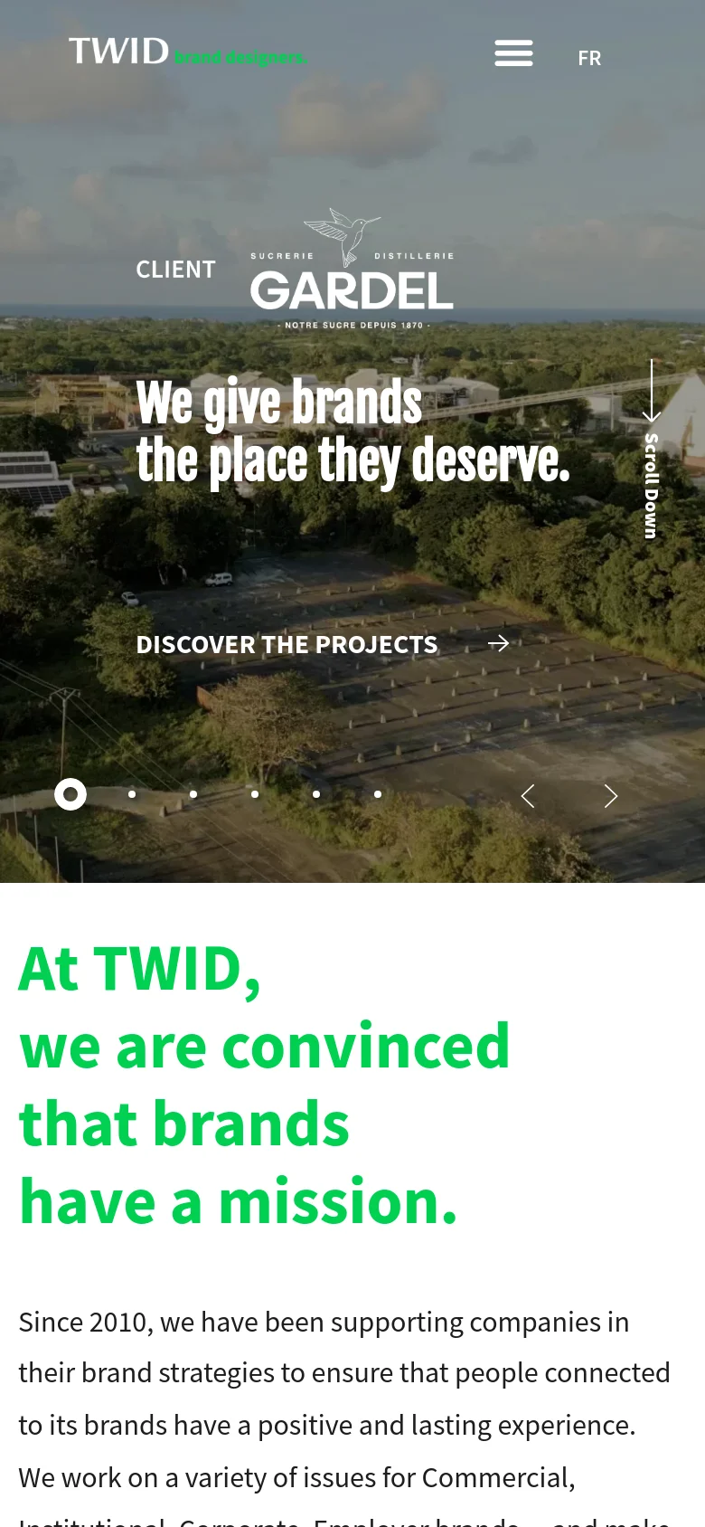 The mobile version maintains the cinematic aerial background but uses a condensed layout. The navigation menu is replaced by a hamburger icon next to the 'FR' language toggle, and the main headline and 'DISCOVER THE PROJECTS' button are centered vertically to fit the narrower screen.