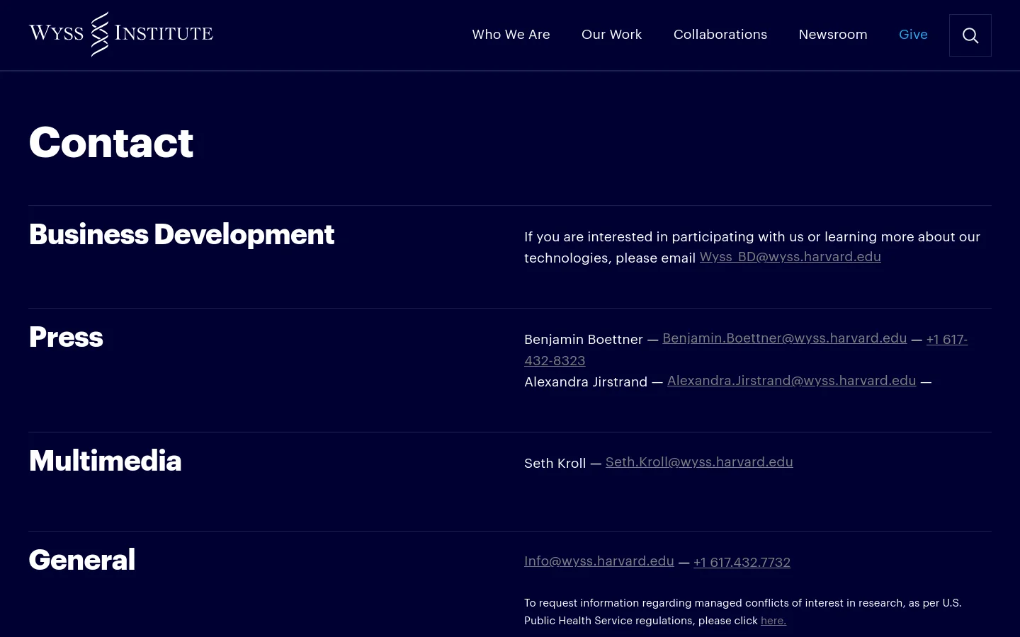 The desktop Contact page features a dark navy background with white text and a clean, minimalist layout. The page is organized into sections for Business Development, Press, Multimedia, and General inquiries, separated by thin horizontal lines. A top navigation bar includes the Wyss Institute logo and links for Who We Are, Our Work, Collaborations, Newsroom, and Give.