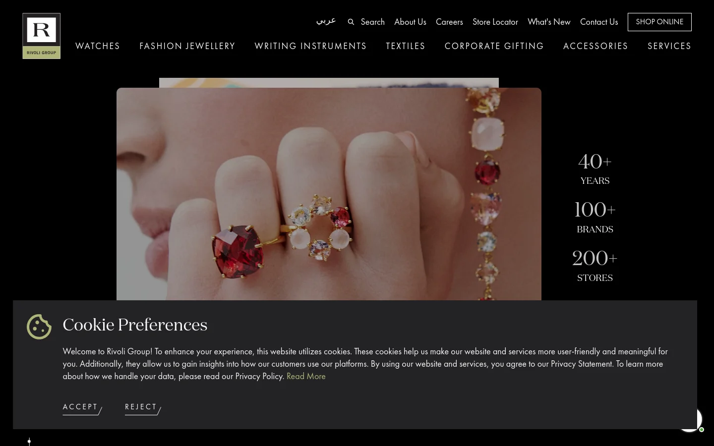 The Rivoli Group homepage features a dark, luxury aesthetic with a large hero image of a person wearing gemstone rings. To the right of the image, white text highlights key statistics: 40+ years, 100+ brands, and 200+ stores. A top navigation bar includes categories like Watches and Fashion Jewellery, alongside utility links like Search and Shop Online.