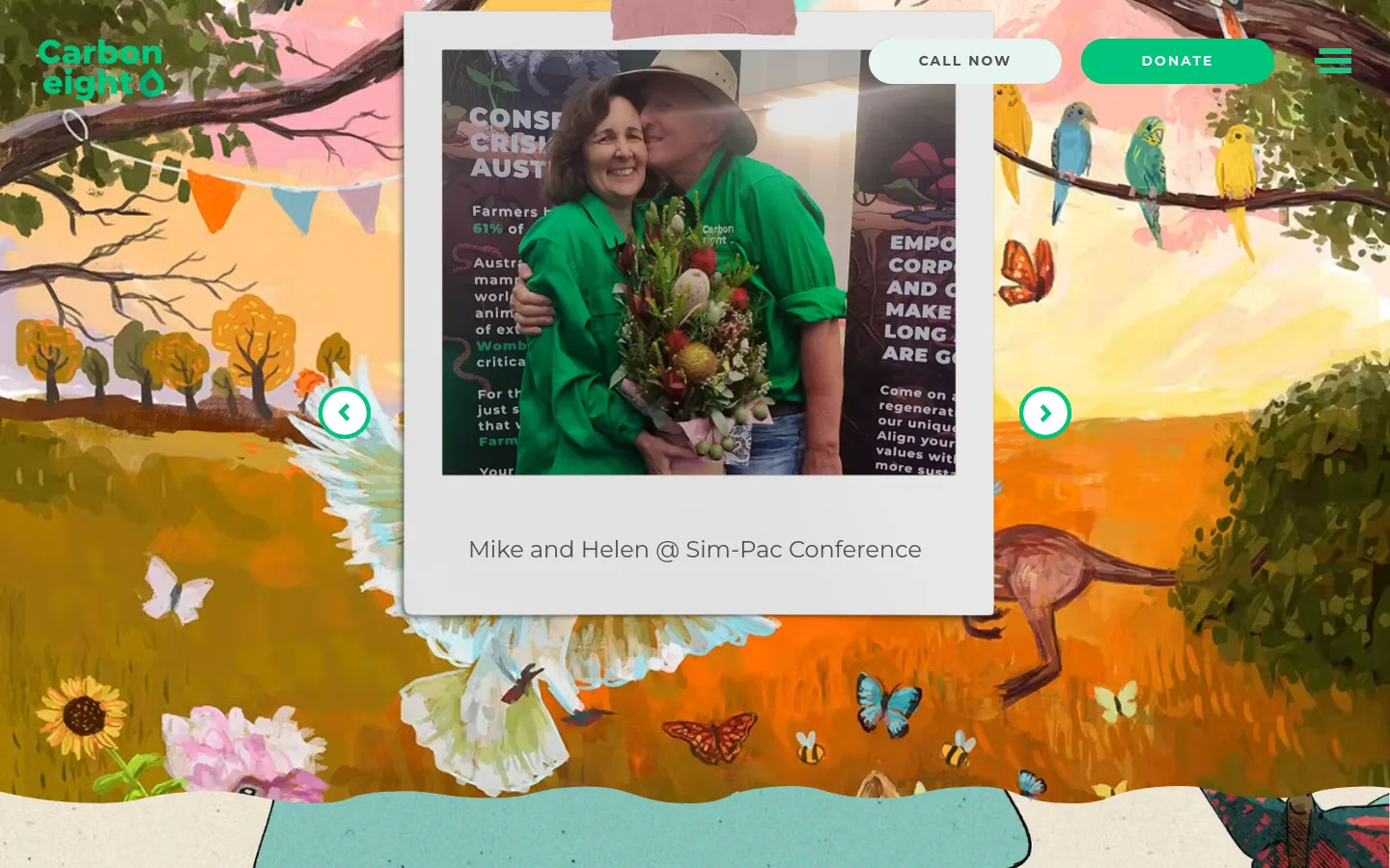The About Us page features a colorful, hand-painted landscape background with birds, flowers, and kangaroos. A central white card displays a Polaroid-style photo of Mike and Helen at the Sim-Pac Conference, with navigation arrows on either side to scroll through other images. The header includes the Carbon8 logo, a 'Call Now' button, a bright green 'Donate' button, and a hamburger menu icon.