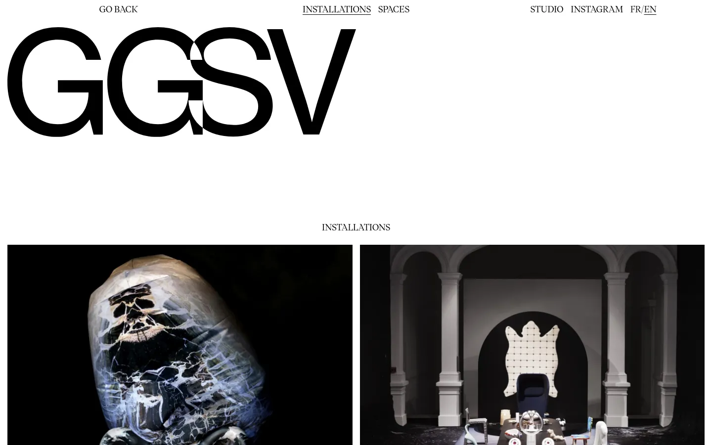 The desktop page features a minimalist white background with large black typography. The header contains navigation links like 'GO BACK', 'INSTALLATIONS', and 'STUDIO'. Below the 'INSTALLATIONS' heading, a grid displays large, square photographic project tiles, such as 'Ghost bless you', which are clickable links to specific installation pages.