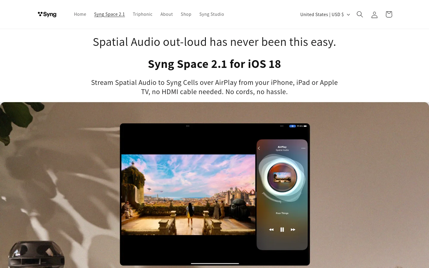 A clean, minimalist desktop layout with a white background and dark text. The hero section features a large headline about Syng Space 2.1 for iOS 18, followed by a high-quality lifestyle image showing an iPad and iPhone displaying spatial audio controls next to a Syng speaker. The navigation bar at the top includes links for Home, Syng Space 2.1, Triphonic, About, Shop, and Syng Studio, alongside search, user, and cart icons.