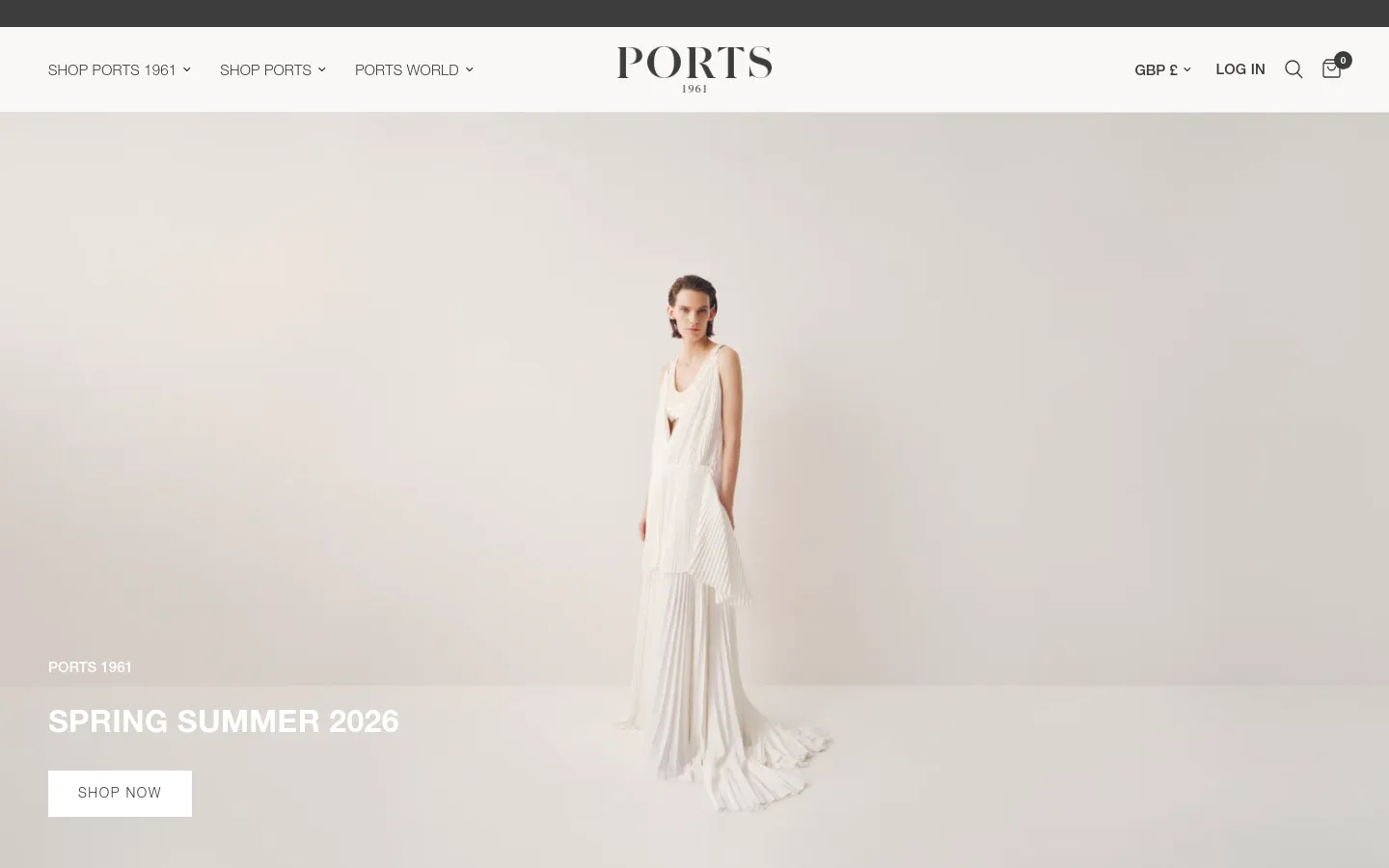 The desktop website features a minimalist white header with the PORTS 1961 logo centered and navigation menus on the left. A large hero image shows a model in a flowing white pleated dress against a neutral background, with the headline 'SPRING SUMMER 2026' and a white 'SHOP NOW' button.