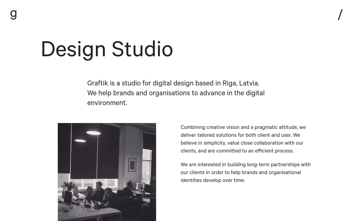 The desktop page features a minimalist white layout with a large 'Design Studio' headline. A centered introductory paragraph is followed by a two-column section containing a black and white GIF of a team working in an office on the left and descriptive text on the right.