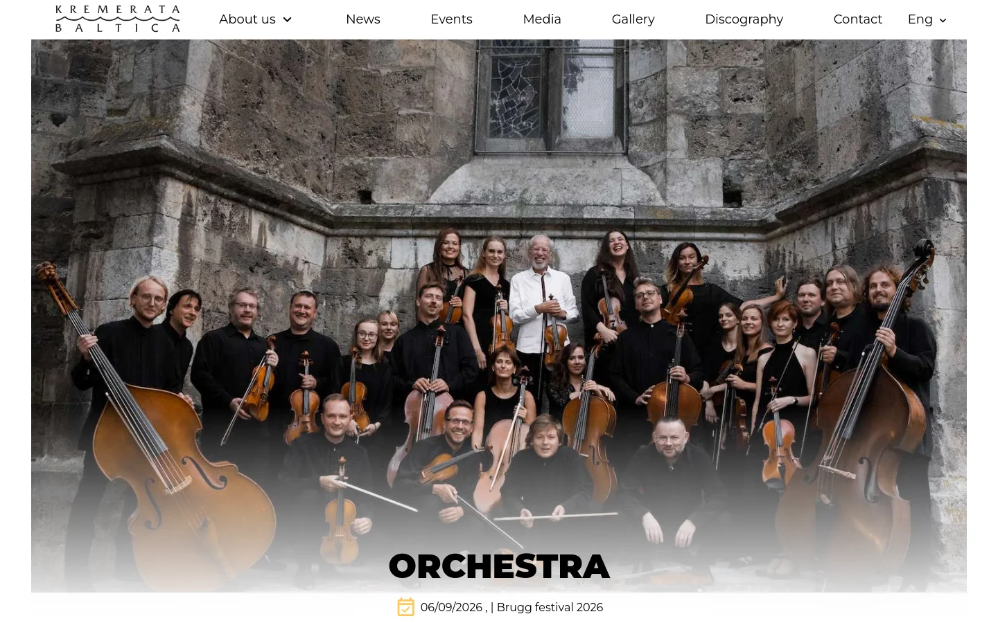 Desktop view of the 'Orchestra' page featuring a large hero image of the chamber orchestra members posed in front of a stone building, holding various string instruments. The Kremerata Baltica logo is in the top left, a navigation menu is at the top, and the word 'ORCHESTRA' is centered in large bold letters at the bottom of the image.