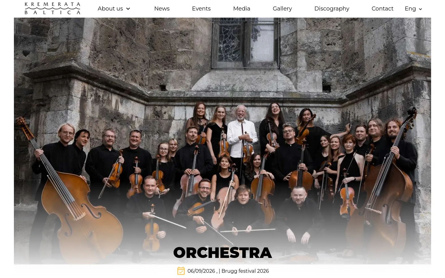 Desktop view of the 'Orchestra' page featuring a large hero image of the chamber orchestra members posed in front of a stone building, holding various string instruments. The Kremerata Baltica logo is in the top left, a navigation menu is at the top, and the word 'ORCHESTRA' is centered in large bold letters at the bottom of the image.