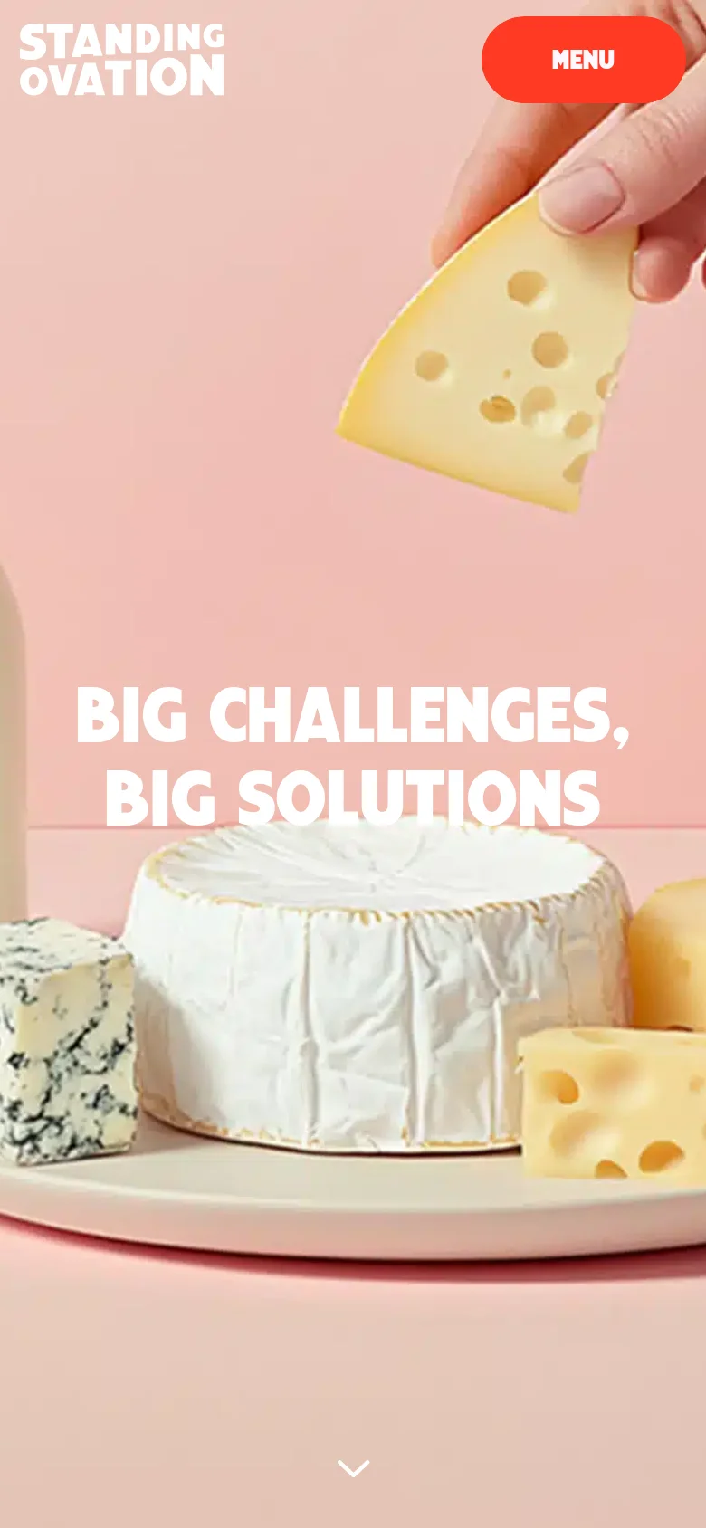 The mobile version displays a vertically cropped version of the hero image, focusing on the hand holding cheese and the headline 'BIG CHALLENGES, BIG SOLUTIONS'. The top navigation bar is replaced by a prominent red 'MENU' button, and the layout is optimized for a single-column vertical scroll.