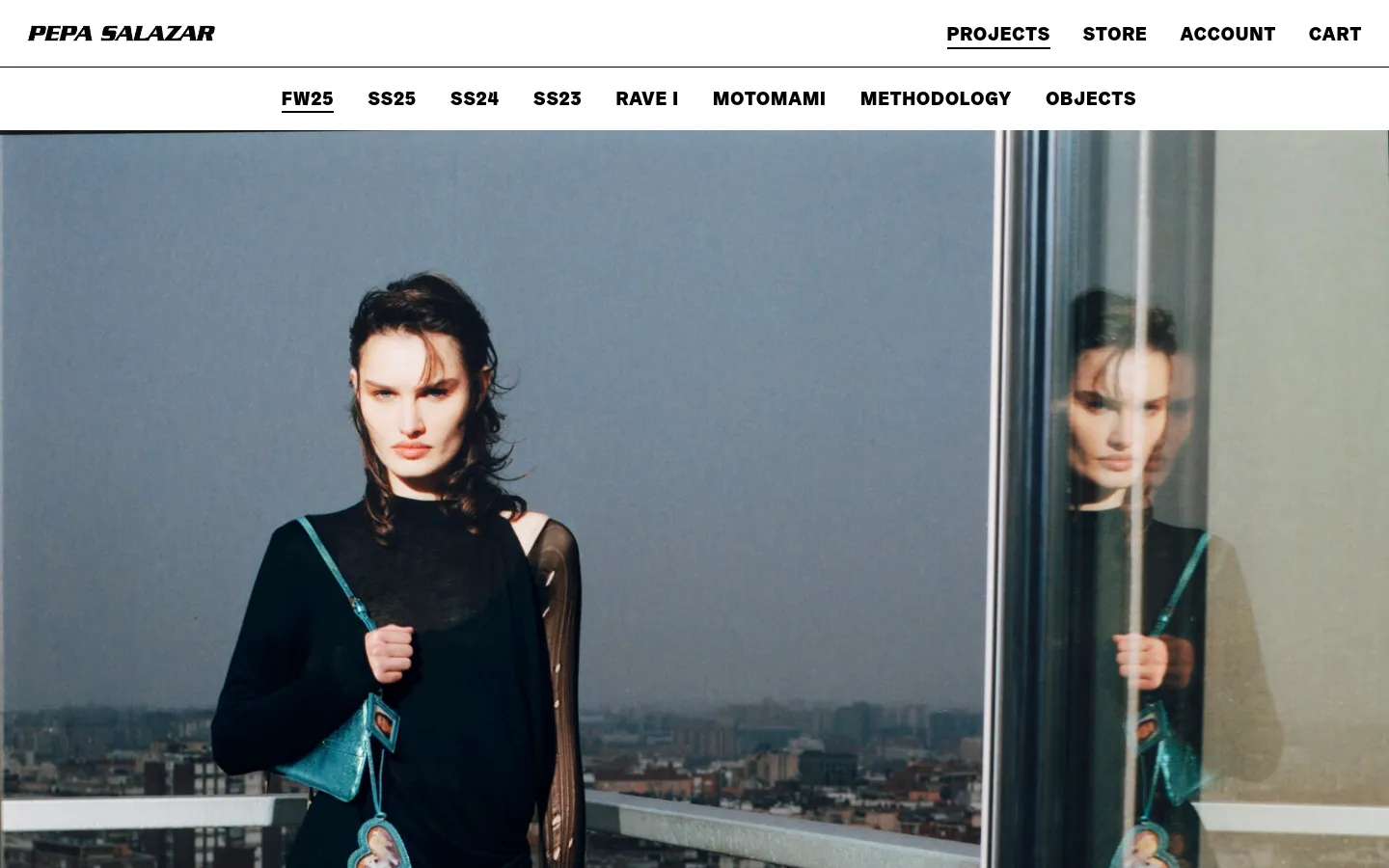 The desktop version of the FW25 project page features a minimalist white header with the PEPA SALAZAR logo and navigation links for Projects, Store, Account, and Cart. Below a secondary sub-navigation menu for specific collections, a large hero image shows a model in a black outfit against a city skyline. The layout is clean with high-contrast black text on a white background.
