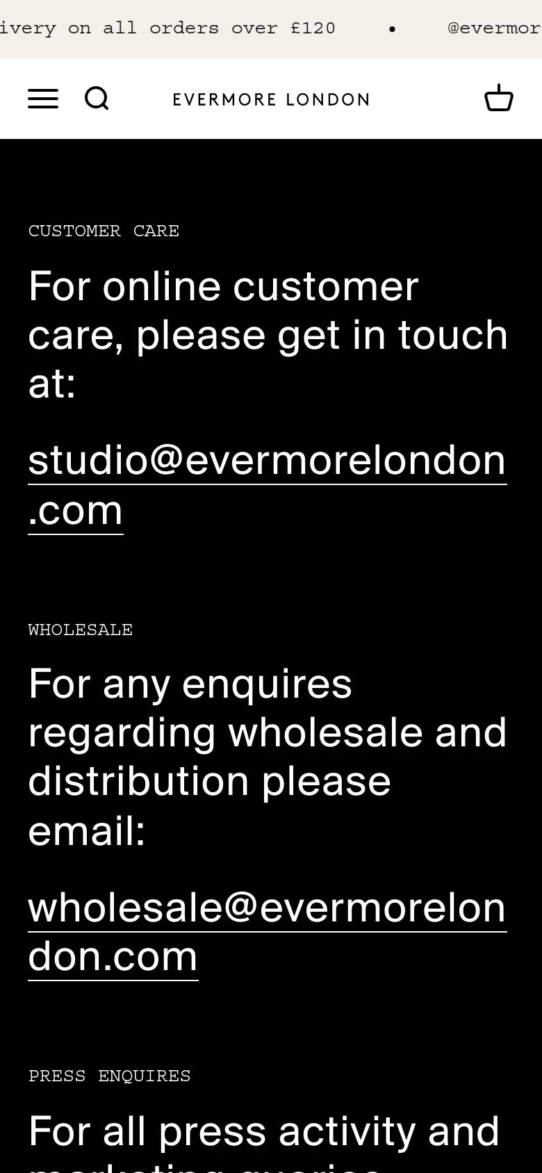 The mobile version maintains the black background and white text but uses a single-column vertical layout for easier scrolling. The navigation is condensed into a hamburger menu and search icon at the top, and the contact email addresses are stacked vertically under their respective headings.
