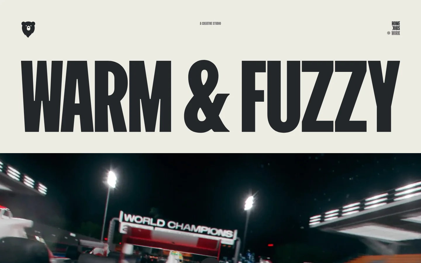The desktop homepage for Warm & Fuzzy, a creative studio, features a minimalist cream background with bold, black typography. The hero section displays the studio name in large uppercase letters above a cinematic video background, with a navigation menu at the top right and a bear logo at the top left.