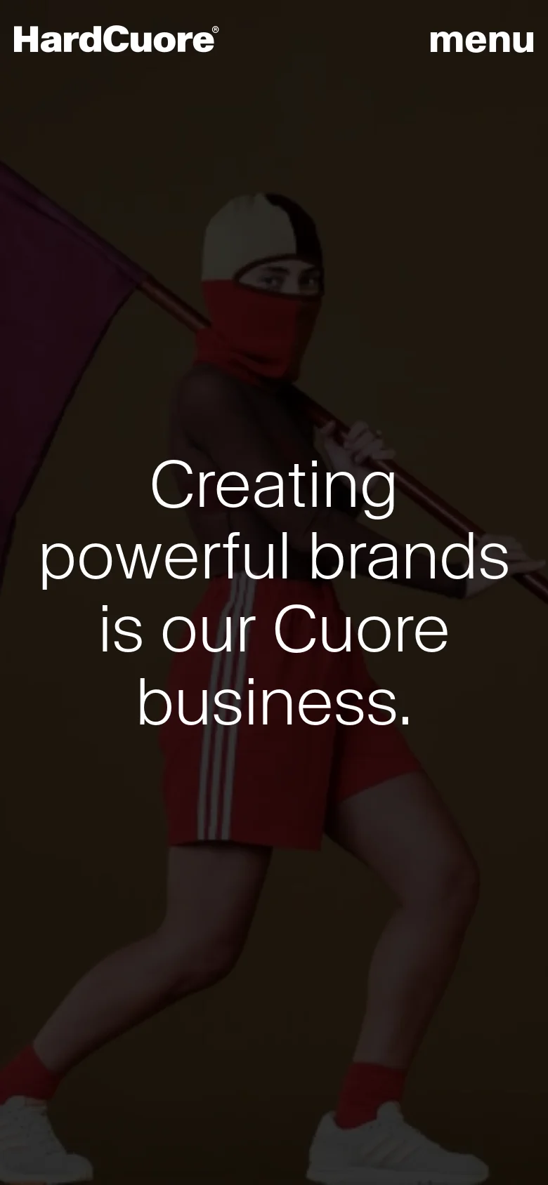 The mobile version presents a vertically stacked layout with the same dark brown theme and hero imagery. The headline is centered and spans multiple lines to fit the narrow screen, and the navigation is simplified with the logo on the left and a 'menu' button on the right.