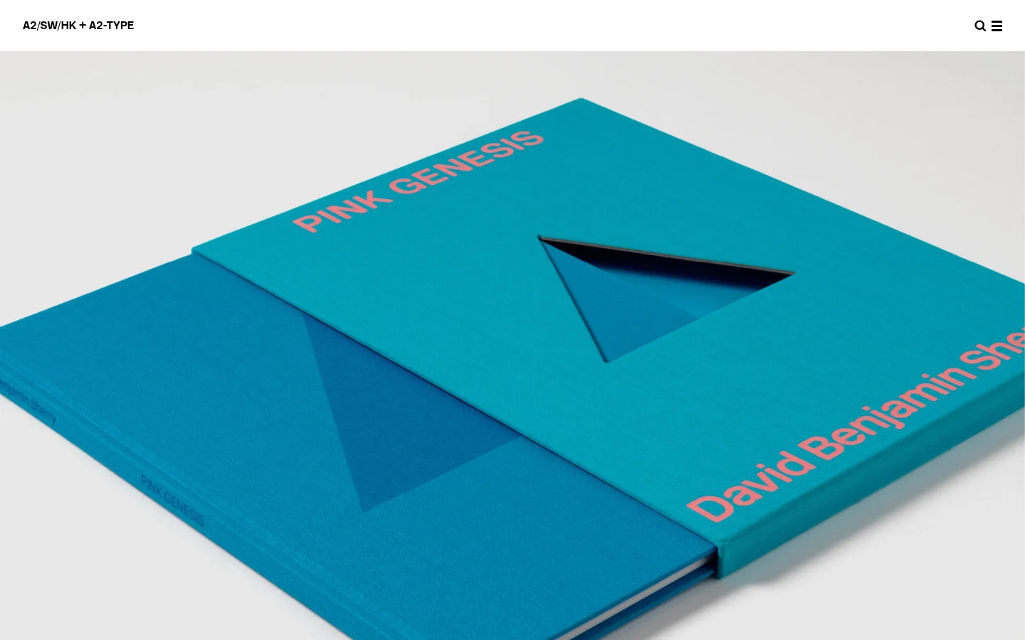 The homepage for A2/SW/HK + A2-TYPE features a minimalist white header with the studio name and search and menu icons. Below, a large hero image shows a close-up, angled view of two bright teal books titled 'PINK GENESIS' with pink typography. The layout is clean and modern, transitioning into a grid of various design project images.