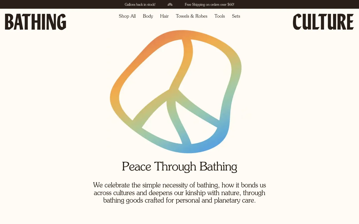 The desktop page features a minimalist design with a large, centered peace sign graphic in soft orange, yellow, and blue gradients. The brand name 'BATHING CULTURE' is split on either side of a top navigation menu, and the headline 'Peace Through Bathing' sits below the icon above a short paragraph of text. The background is a clean, off-white color.