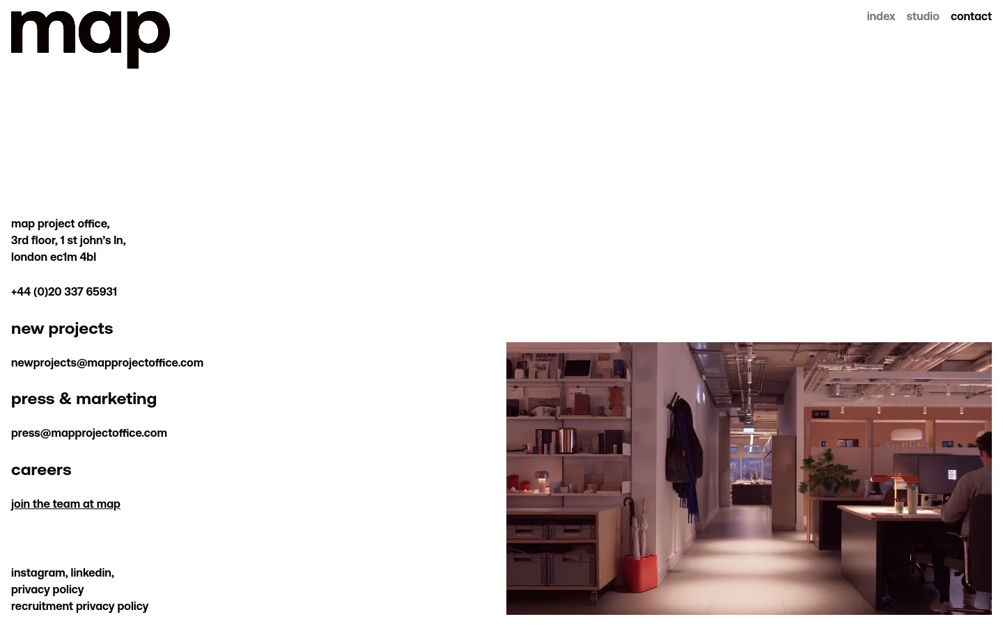 The desktop contact page features a minimalist white layout with black sans-serif text. The left side lists the office address, phone number, and three categorized contact sections: new projects, press & marketing, and careers, followed by social links and legal policies. A large photograph of a modern, brightly lit office interior occupies the bottom right quadrant.
