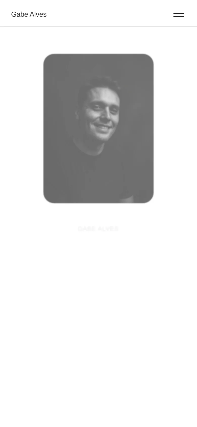The mobile version presents a simplified vertical layout with the black and white portrait at the top, followed by the biography. The navigation is condensed into a hamburger menu icon in the top right corner, and the text is centered for readability on smaller screens.