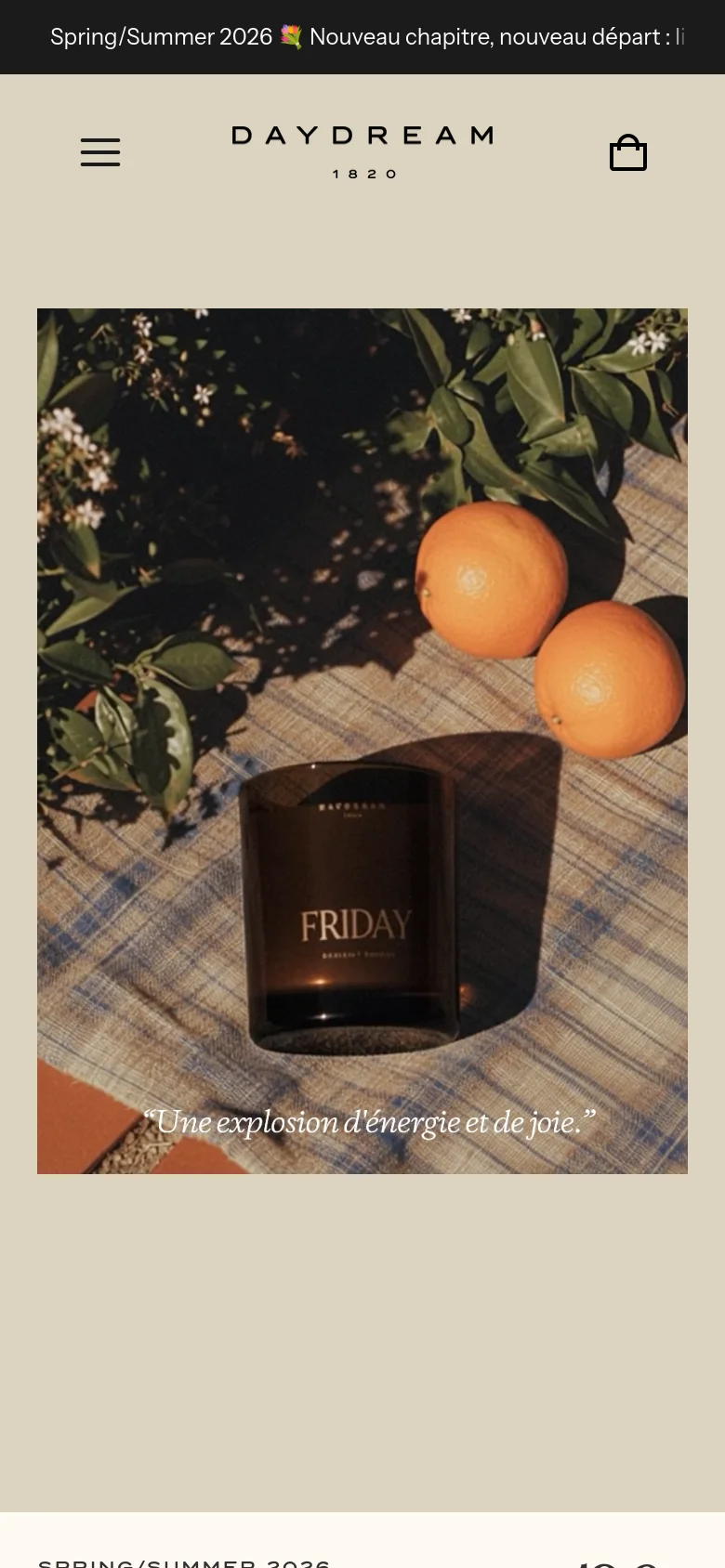 The mobile version presents a vertically stacked layout, focusing on a large, full-width hero image of the 'Friday' candle and oranges on a checkered cloth. The navigation is condensed into a hamburger menu at the top left, with the brand logo centered and a shopping bag icon on the right.