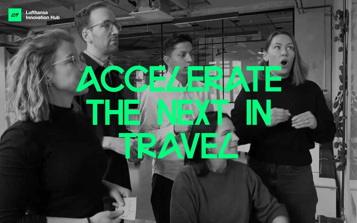 The desktop homepage features a large black-and-white hero image of a diverse group of people in an office setting, overlaid with the large teal headline 'ACCELERATE THE NEXT IN TRAVEL'. The Lufthansa Innovation Hub logo is in the top left, and a menu icon is in the top right. The layout is clean with a dark color palette and high-contrast teal accents.