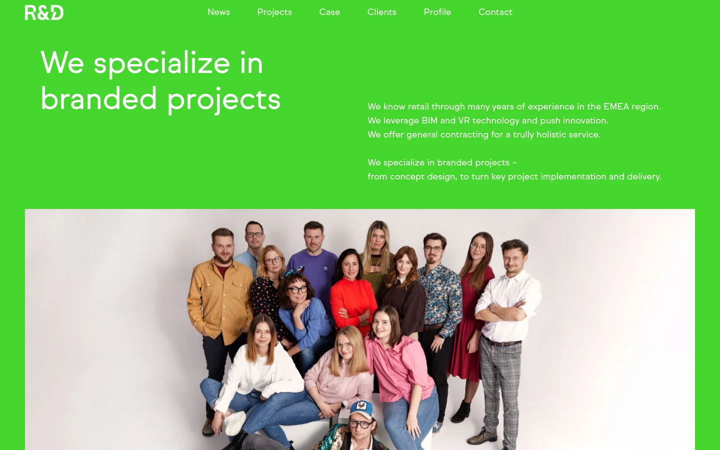 The desktop profile page features a bright green header with the white headline 'We specialize in branded projects' and a brief description of the company's expertise. Below the text is a large group photograph of the R&D team against a light background. A navigation menu is visible at the top with links to News, Projects, Case, Clients, Profile, and Contact.