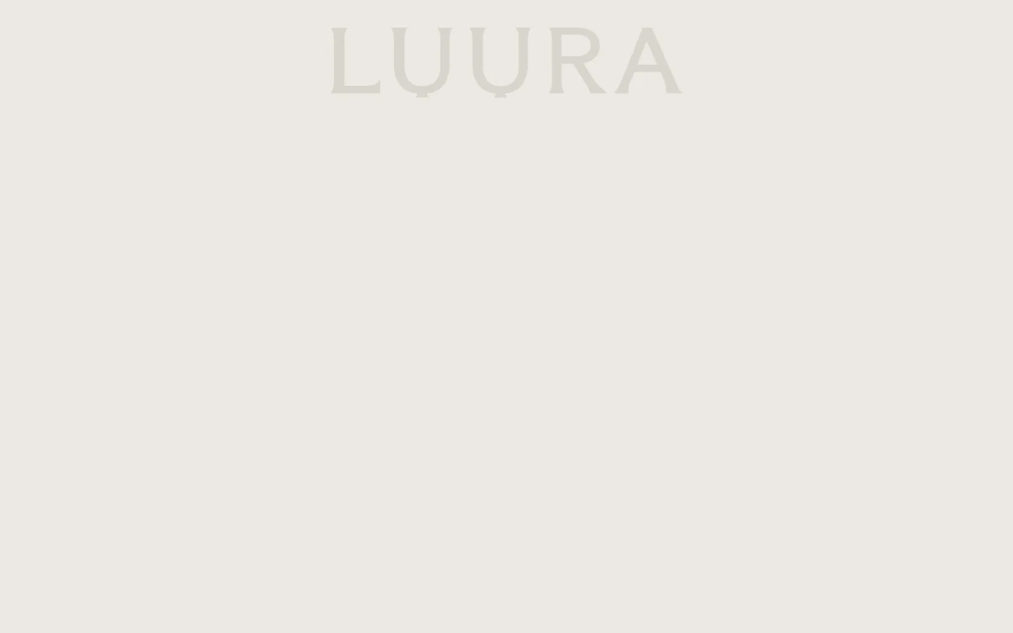 The desktop About page features a minimalist design with a large, centered 'LUURA' logo in a serif font against a neutral, cream-colored background. Below the header, a large hero image shows a close-up of hands holding a dark, textured ceramic vessel. The layout is spacious and clean, emphasizing a sophisticated and artistic aesthetic.