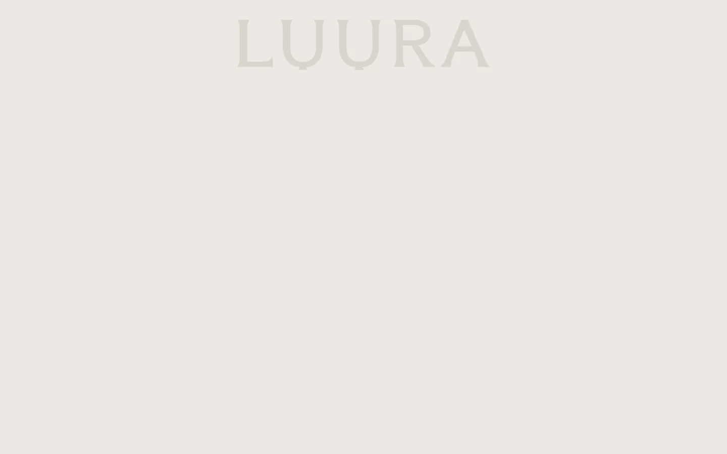The desktop About page features a minimalist design with a large, centered 'LUURA' logo in a serif font against a neutral, cream-colored background. Below the header, a large hero image shows a close-up of hands holding a dark, textured ceramic vessel. The layout is spacious and clean, emphasizing a sophisticated and artistic aesthetic.