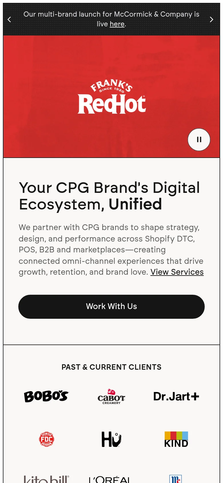 The mobile version stacks the hero content vertically, placing the headline and 'Work With Us' button above a full-width image of the RedHot product collage. The client logo grid follows below, with the logos arranged in a more compact, multi-row layout to fit the narrow screen. The color palette remains consistent with white, red, and light gray tones.