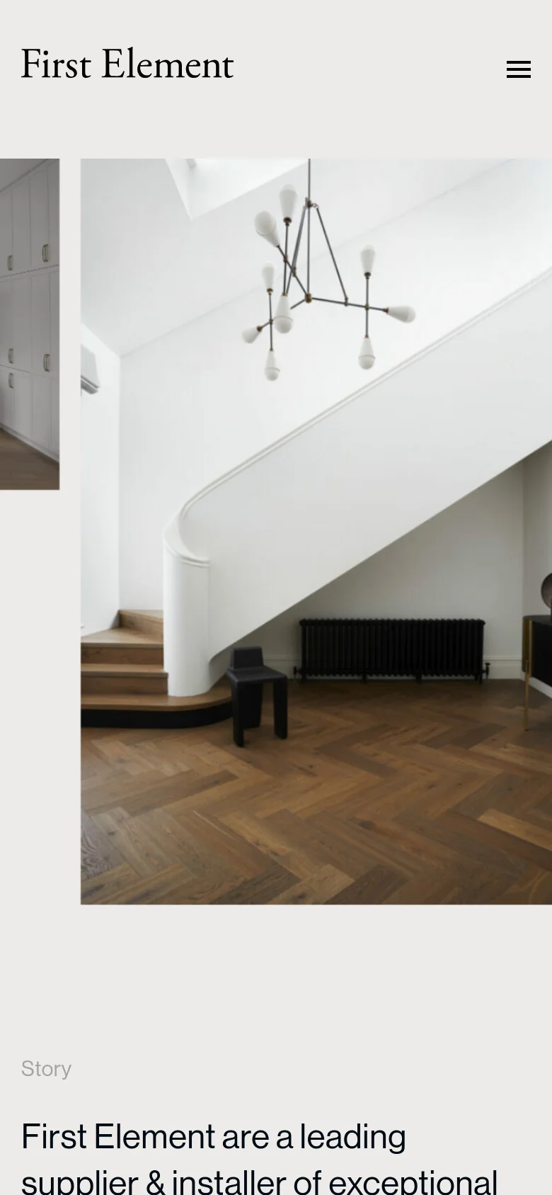 The mobile version presents a simplified layout with a hamburger menu icon in the top right and the First Element logo on the left. The hero imagery is stacked vertically, focusing on a large image of a modern interior with dark wood herringbone flooring and a white staircase. The text 'Story' and a headline about being a leading supplier appear below the main image.