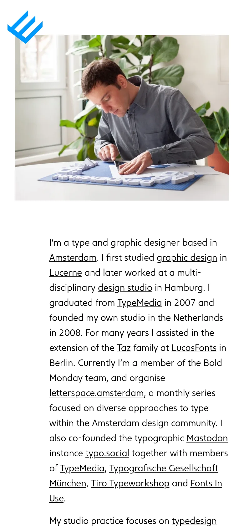 The mobile version presents a single-column vertical layout. The large hero image of the designer is centered at the top, followed by the biographical text which spans the full width of the screen. The sidebar navigation is removed to prioritize the content flow.