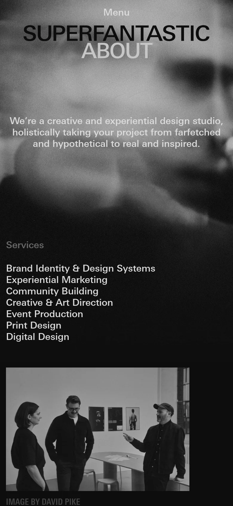 The mobile version uses a dark, moody aesthetic with a blurred background image and white text. The layout is vertically stacked, starting with a 'Menu' button and the 'SUPERFANTASTIC' brand name, followed by an 'ABOUT' section and a list of services like Brand Identity and Experiential Marketing. A black-and-white photograph of three people is positioned at the bottom of the view.