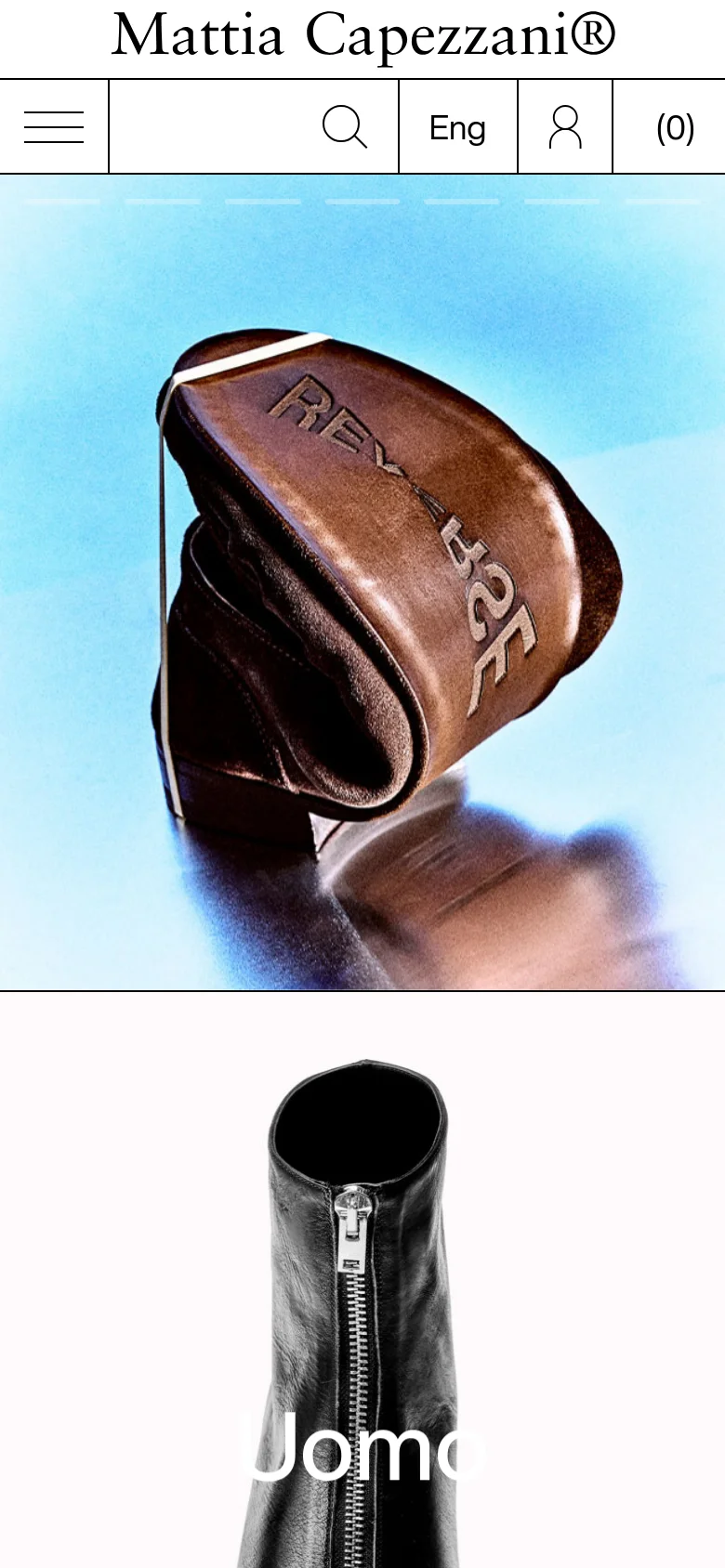 The mobile version features a condensed header with a hamburger menu icon, a search icon, language selection, a user profile icon, and a shopping bag icon. The hero image is vertically oriented, showcasing a close-up of a brown leather accessory against a light blue background with the word 'Uomo' overlaid in white text.